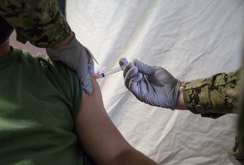 U.S. Marines and sailors with III Marine Expeditionary Force receive COVID-19 vaccines at the U.S. Naval Hospital Okinawa, Camp Foster, Okinawa, Japan, Jan. 12, 2021. Marine Forces Japan is using the DoD’s phased approach to vaccinate all active component, reserve component, TRICARE prime and TRICARE select beneficiaries, and select DoD civilians and contract personnel authorized to receive immunizations from DoD, to remain a lethal and ready expeditionary fighting force. (U.S. Marine Corps photo by Cpl. Francesca Landis)