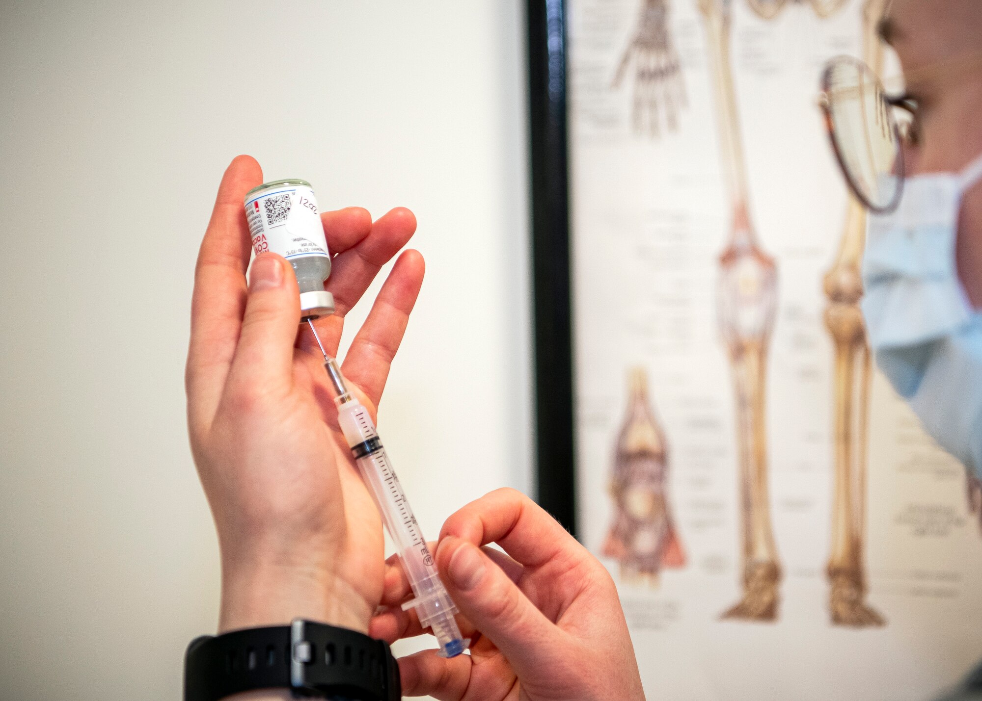 Staff Sgt. Morgan Mack, 423rd MDS NCO in charge of immunizations, prepares to administer the COVID-19 vaccine at RAF Alconbury, England, Jan. 7, 2020. Department of Defense Education Activity teachers are receiving the vaccine in an effort to reduce the potential spread of COVID-19 within the schools and community. (U.S. Air Force photo by Senior Airman Eugene Oliver)