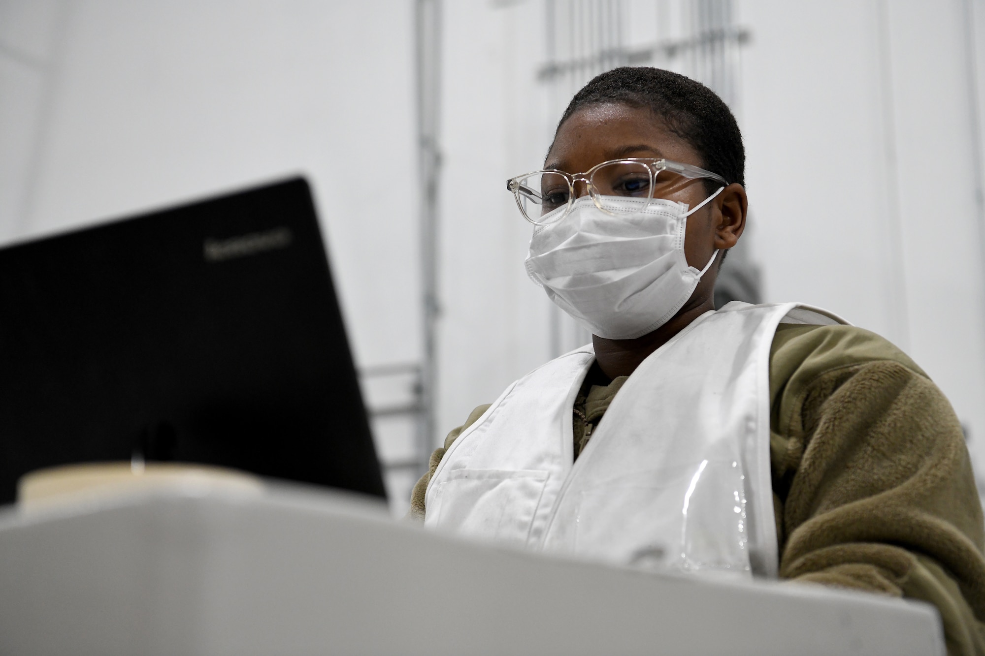 An Airman works at a computer.