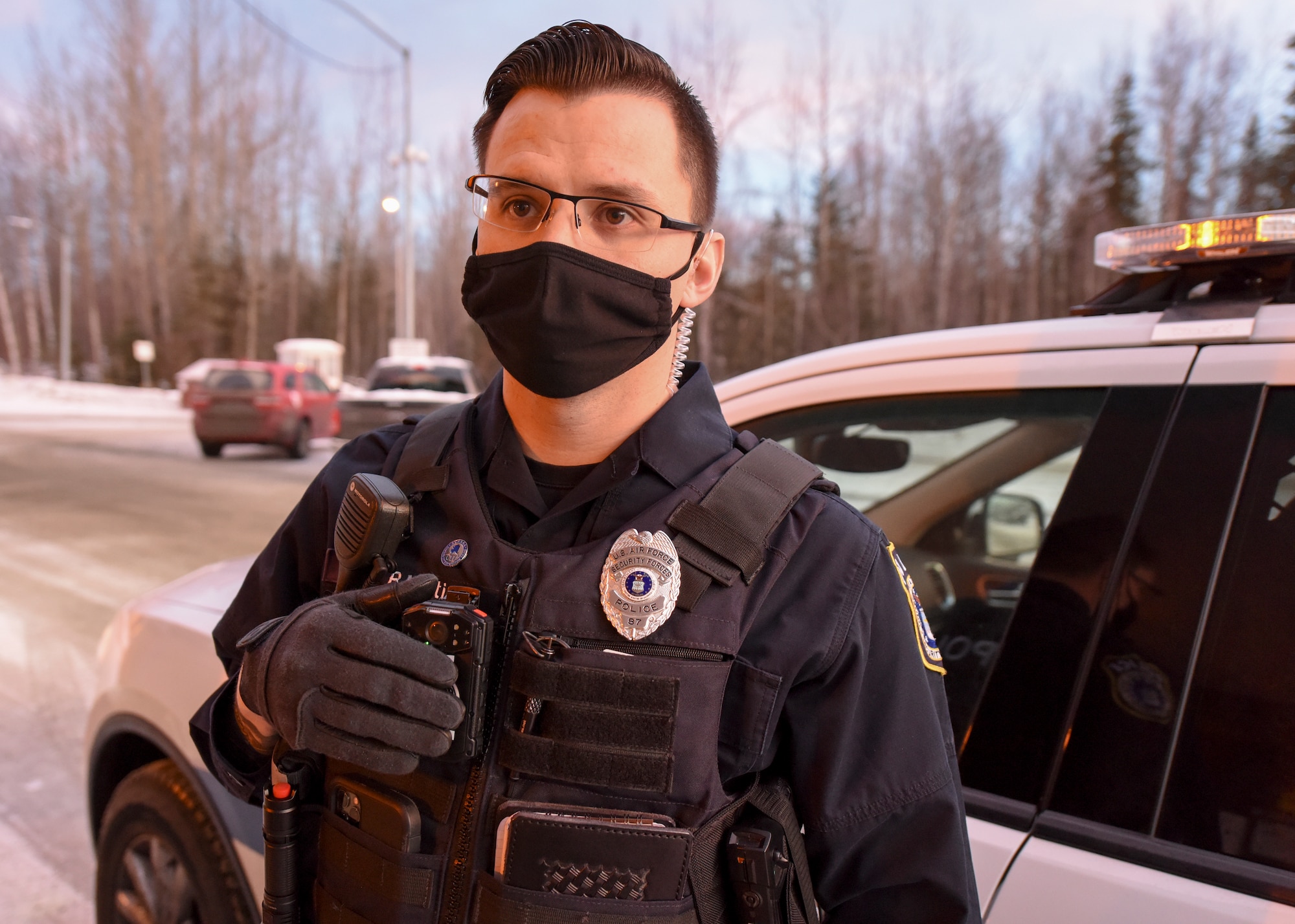 Department of Defense Police Officer Richard Martinez, a patrol officer with the 673d Security Forces Squadron turns on a new body camera during a routine stop Jan. 8, 2021, at Joint Base Elmendorf-Richardson, Alaska. The 673d SFS has begun integrating 60 new, high-tech body cameras into daily operations after the adaptable technology reached a point of not only being a reliable safety and training instrument, but a multifunctional accountability tool serving all. (U.S. Air Force photo by Senior Airman Crystal A. Jenkins)