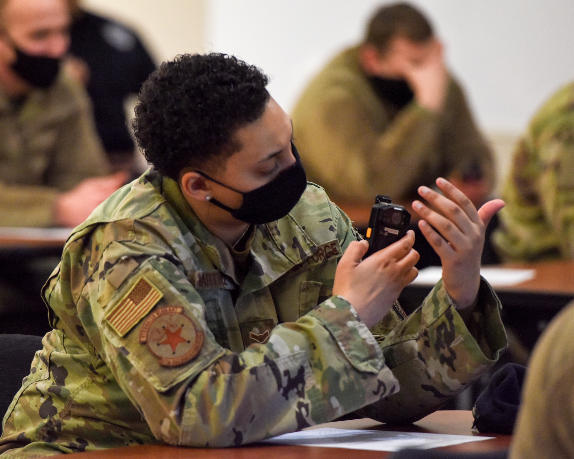 U.S. Air Force Airman 1st Class Gisely Martinez, a 673d Security Forces Squadron entry controller, looks at the wide angle view on a new body camera to become familiar with the device's features during a training day Jan. 6, 2021, at Joint Base Elmendorf-Richardson, Alaska. The 673d SFS has begun integrating 60 new, high-tech body cameras into daily operations after the adaptable technology reached a point of not only being a reliable safety and training instrument, but a multifunctional accountability tool serving all. (U.S. Air Force photo by Senior Airman Crystal A. Jenkins)