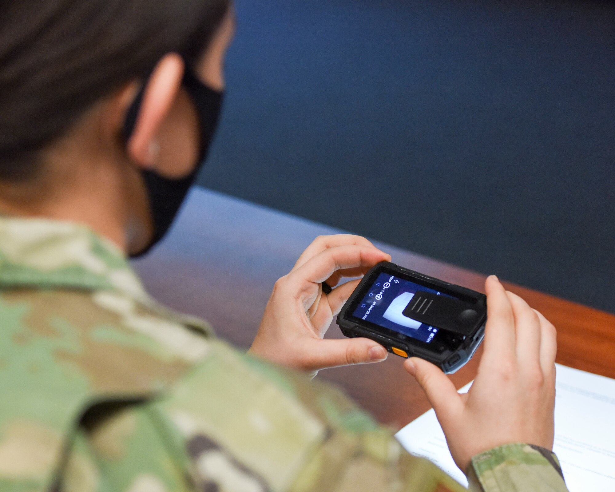 U.S. Air Force Airman 1st Class Kelly Griffith, a 673d Security Forces Squadron patrolman, presses buttons on a new body camera to become familiar with the device's features during a training day Jan. 6, 2021, at Joint Base Elmendorf-Richardson, Alaska. The 673d SFS has begun integrating 60 new, high-tech body cameras into daily operations after the adaptable technology reached a point of not only being a reliable safety and training instrument, but a multifunctional accountability tool serving all. (U.S. Air Force photo by Senior Airman Crystal A. Jenkins)