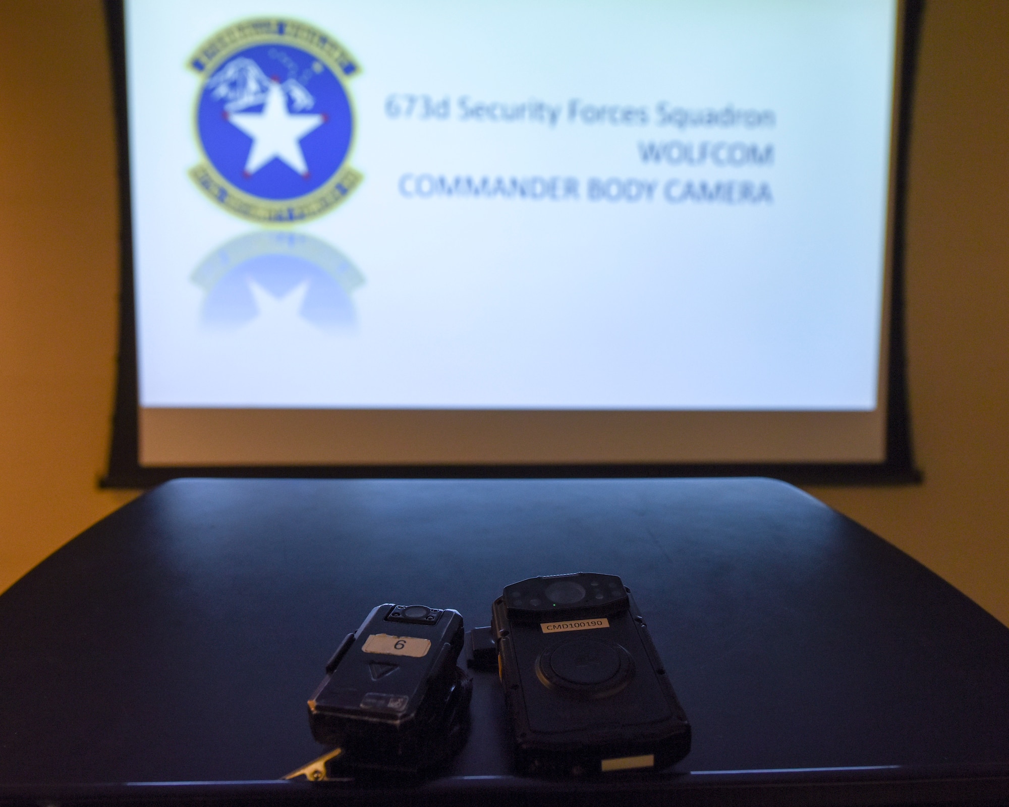 An old and new body camera sit side-by-side during a 673d Security Forces Squadron S3T body camera training Jan. 6, 2021, at Joint Base Elmendorf-Richardson, Alaska. The 673d SFS has begun integrating 60 new, high-tech body cameras into daily operations after the adaptable technology reached a point of not only being a reliable safety and training instrument, but a multifunctional accountability tool serving all. (U.S. Air Force photo by Senior Airman Crystal A. Jenkins)