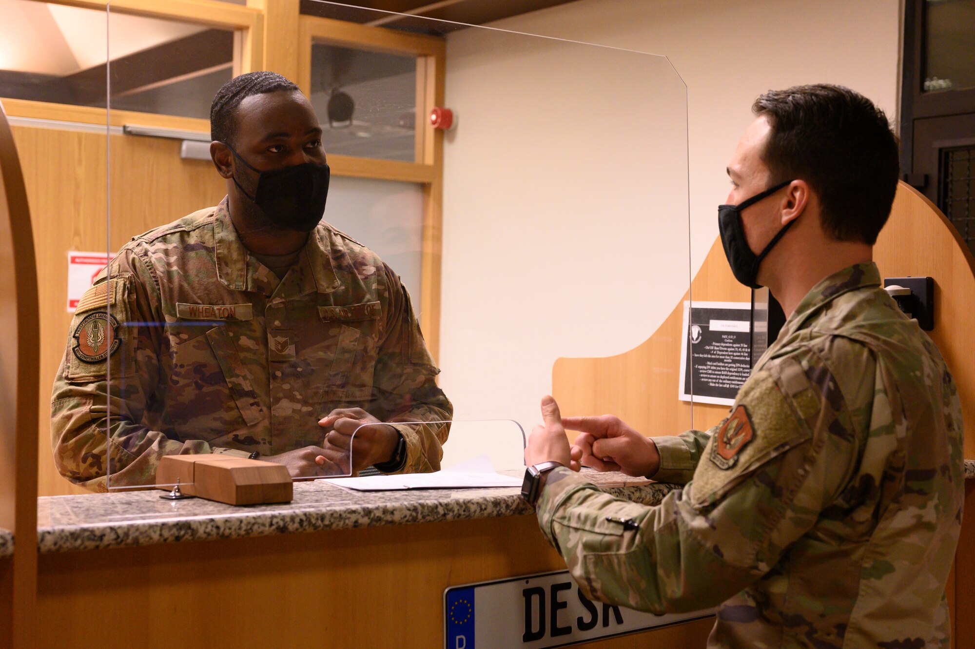 A photo of an Airman fielding customer service questions.