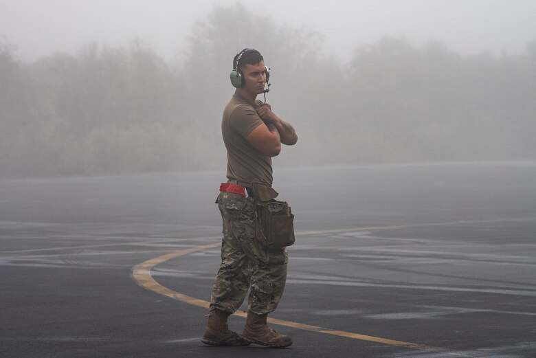 An Airman assigned to the 480th Expeditionary Fighter Squadron (EFS) signals a pilot preparing to taxi at Al Dhafra Air Base (ADAB), United Arab Emirates, Jan. 19, 2021.