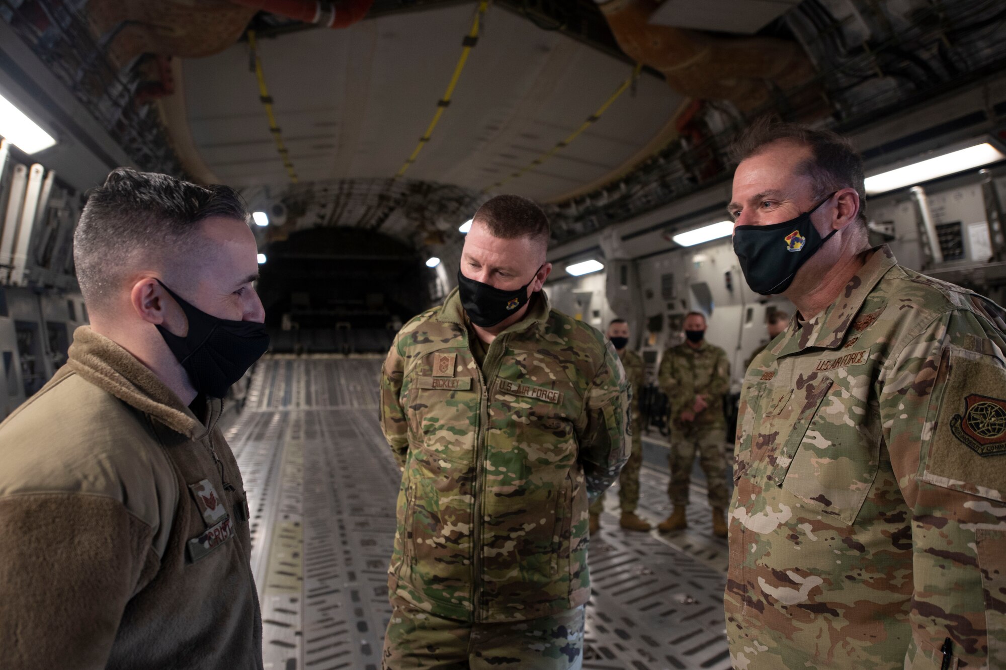 Photo of Airmen speaking to one another.