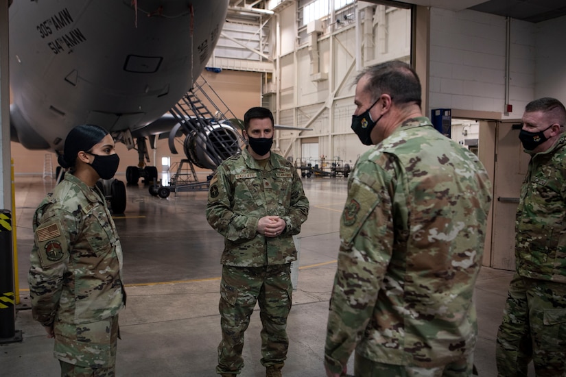 Photo of Airmen speaking to one another.
