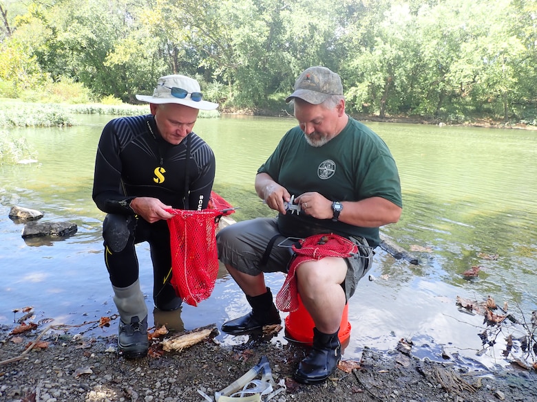 Jason Wisniewski (Right) and Don Hubbs, Tennessee Wildlife Resources Agency wildlife biologists, measure the size of recaptured mussels Sept. 17, 2019 at Lillards Mill on the Duck River in Lewisburg, Tennessee, as part of the recovery efforts of the Cumberland River Aquatic Center. When the U.S. Army Corps of Engineers Nashville District lowered Lake Cumberland in Kentucky in 2008 to relieve pressure on Wolf Creek Dam, an agreement with the U.S. Fish and Wildlife Service to mitigate environmental impacts resulted in mitigation dollars being committed to the aquatic center. (Photo by Dan Hua)