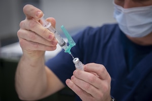 A health services technician at Coast Guard Base New Orleans prepares a COVID19 vaccine dose at Base New Orleans, January 19, 2021.