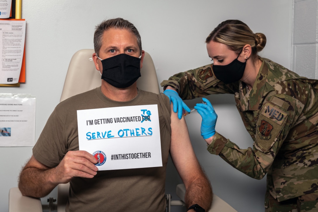 U.S. Air Force Lt. Col. Joseph Sander, a personnel officer with the 182nd Force Support Squadron, Illinois Air National Guard, receives the first of a 2-series COVID-19 vaccination from 182nd Medical Group aerospace medical service specialist Tech. Sgt. Katie Gonder in Peoria, Illinois.