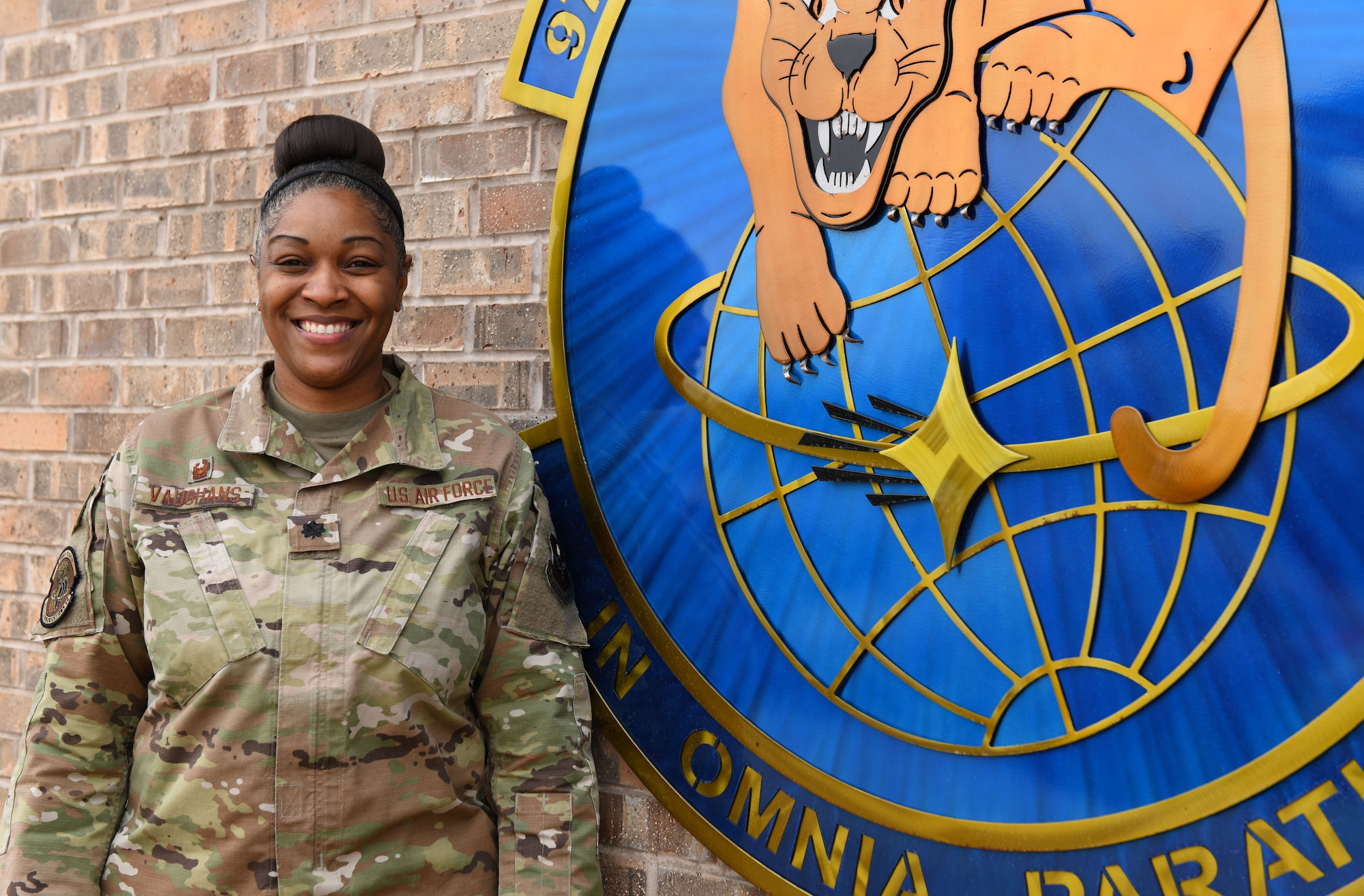 Lt. Col. Marshalria Vaughans, 97th Communications Squadron (CS) commander, stands next to the 97th CS logo on Jan. 20, 2020, at Altus Air Force Base, Oklahoma. Vaughans applied to transfer into the U.S. Space Force in May of 2020 and learned she’d been accepted in October of 2020. She is slated to become one of 150 cyber officers in the entire branch. (U.S. Air Force photo by Airman 1st Class Amanda Lovelace)