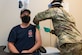 Rob Taylor, a Dobbins firefighter, is the first person to receive the COVID-19 vaccination at Dobbins Air Reserve Base, Ga. on Jan. 22, 2020. Also in the first wave of vaccinations were other firefighters as well as security forces Airmen from Dobbins. (U.S. Air Force photo/Andrew Park)