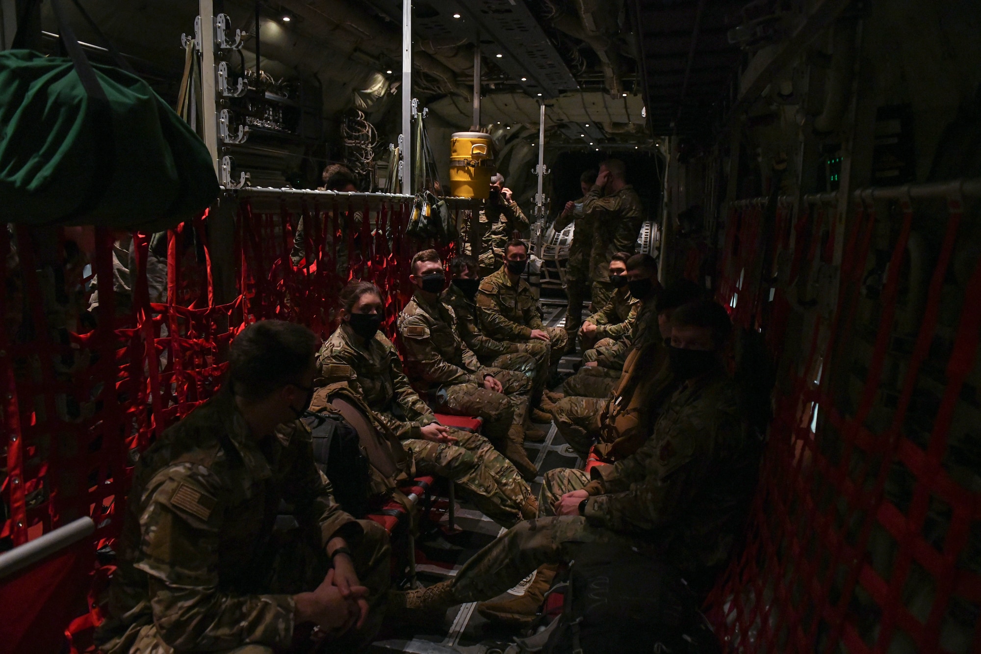 A group of people sit on an aircraft