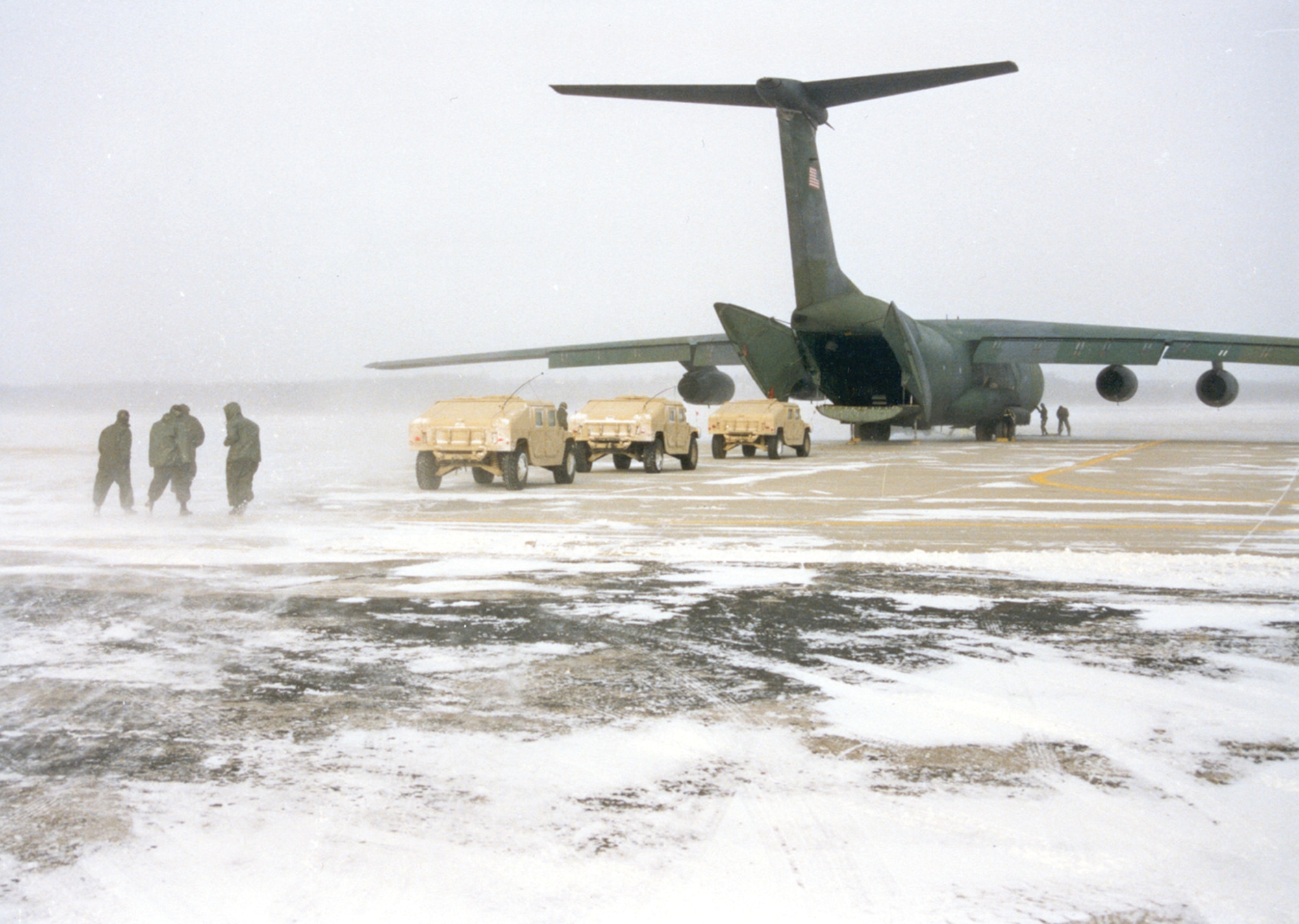 Army vehicles on flight line photo