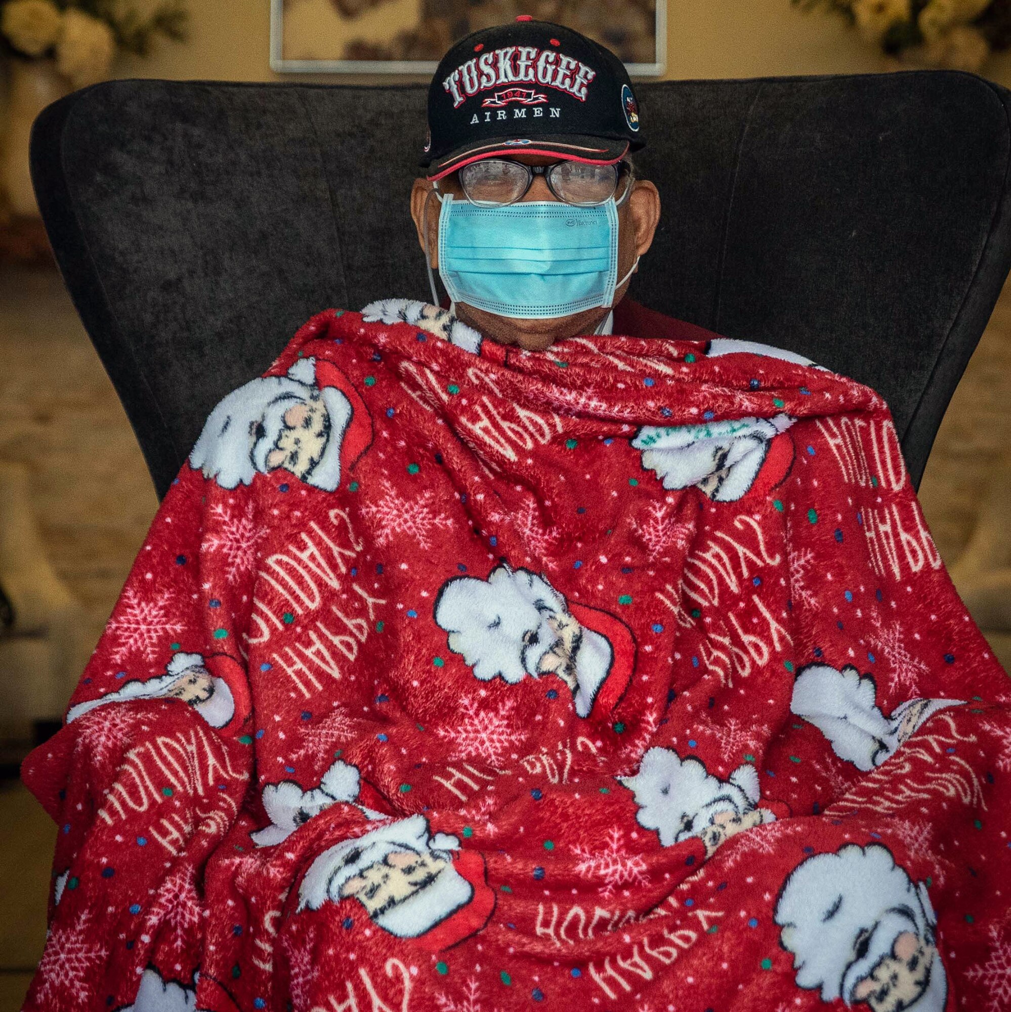 Retired Master Sgt. James Bynum, a documented Original Tuskegee Airman, watches a car parade being held in his honor for his 100th birthday celebration Jan. 9 at the Grandview Assisted Living Facility in San Antonio. To celebrate the milestone, the Tuskegee Airmen San Antonio Chapter held a drive-thru car parade where close to a 100 cars showed up to wish him a happy birthday.