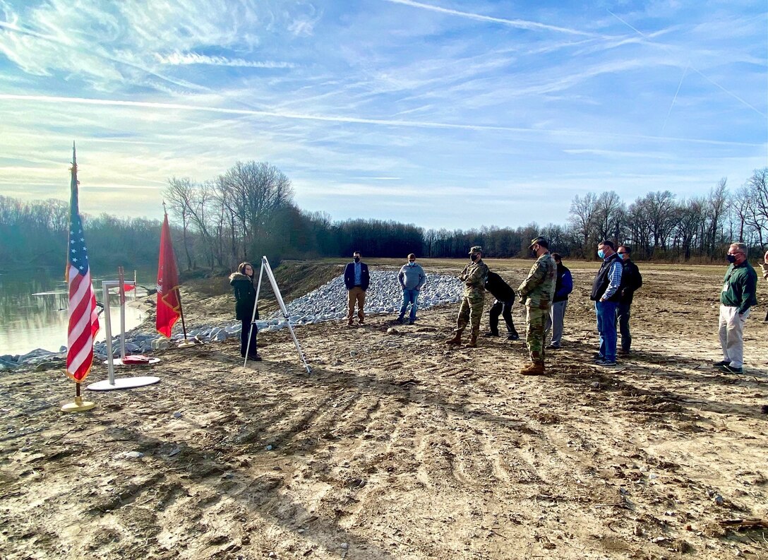 IN THE PHOTO, Memphis District Commander Col. Zachary Miller and other district leadership are briefed on the details of the St. Francis bridge (CR736) project at the exact site where the construction took place. Afterward, the group held a ribbon-cutting ceremony, symbolizing the victory and celebration of completing yet another significant project. (USACE photo by Jessica Haas)