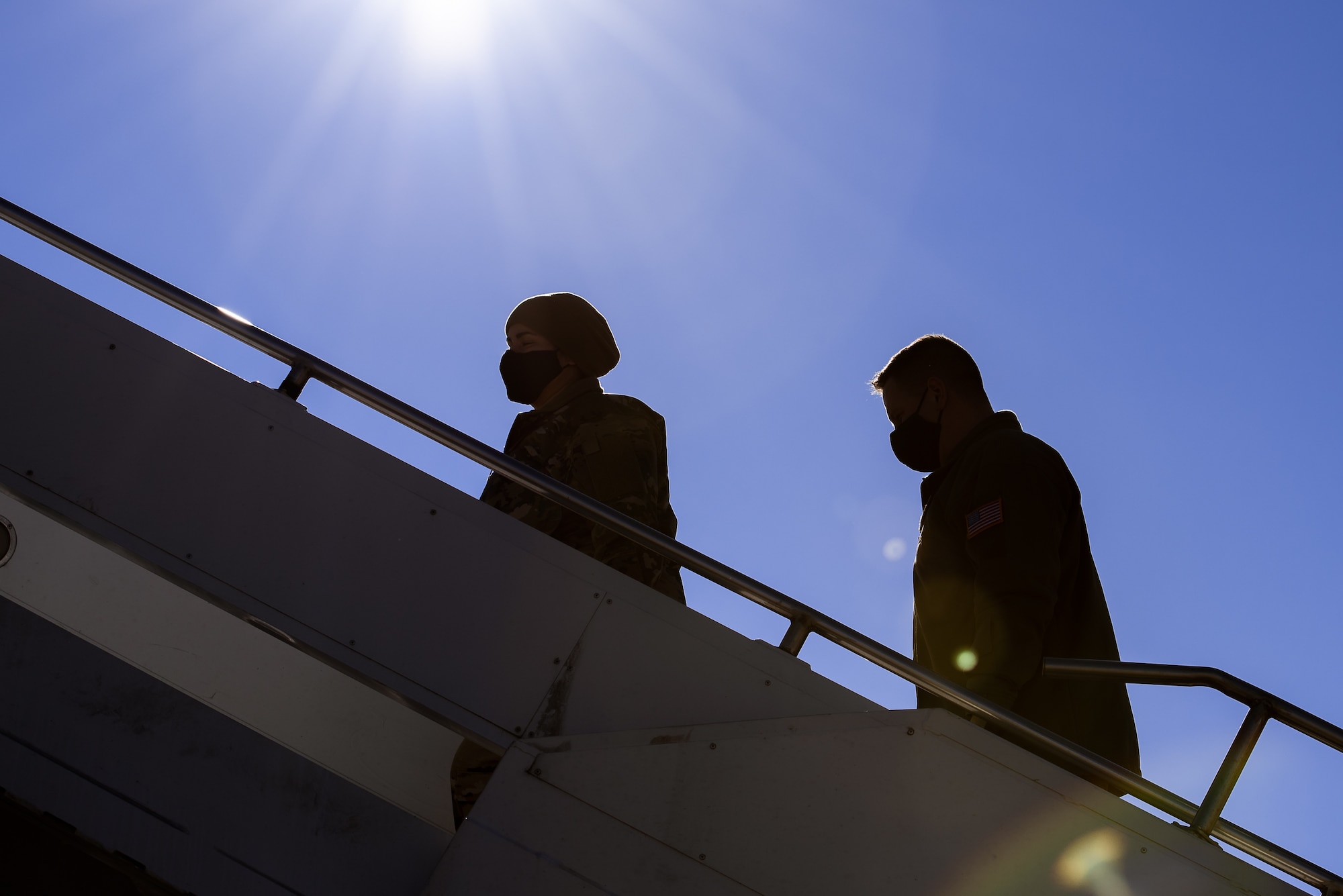 Airmen walk up aircraft ramp