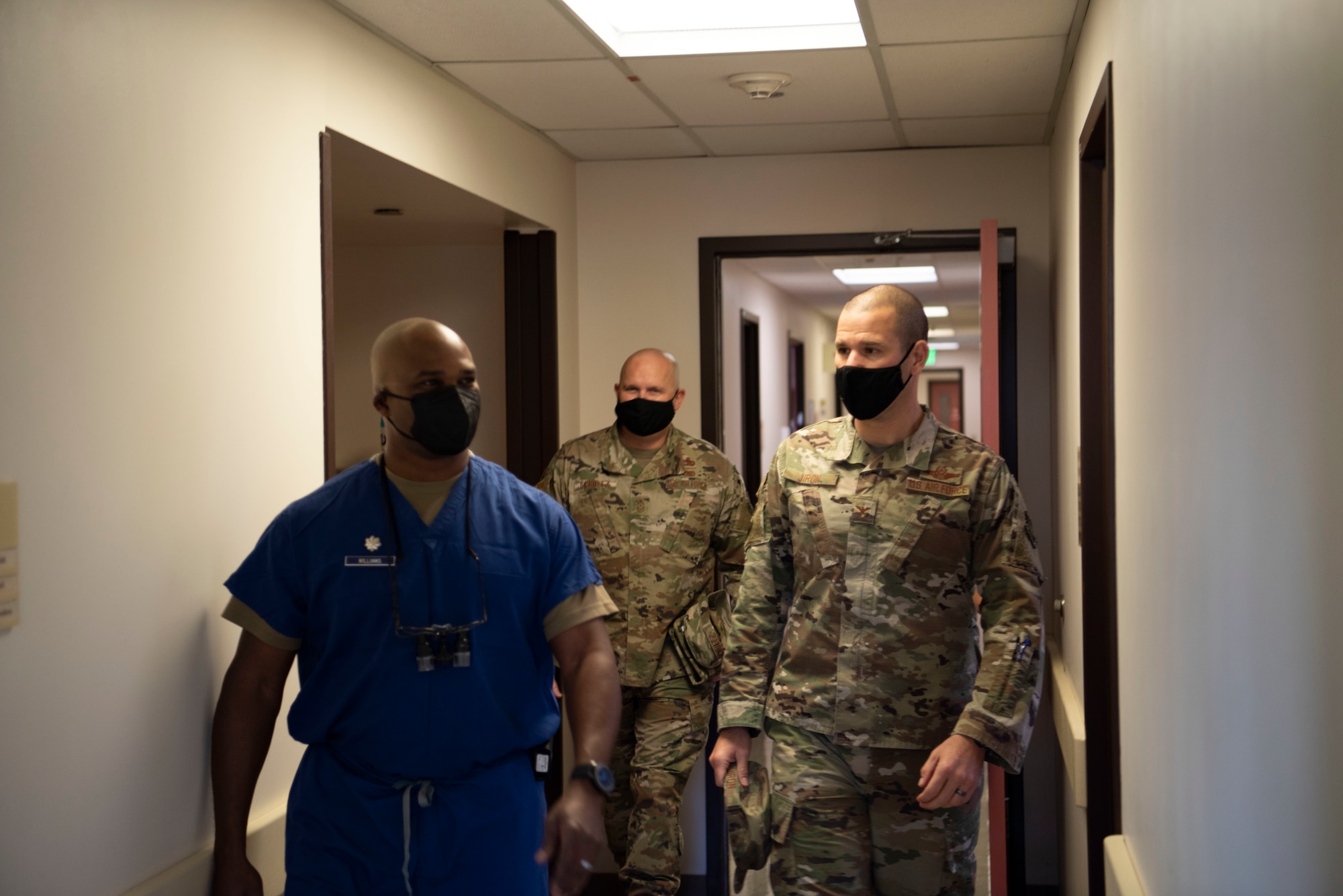 U.S. Air Force Lt. Col. Bryan Williams, left, 60th Dental Squadron flight commander, escorts Col. Zachery Jiron, right, 60th Air Mobility Wing vice commander, and Chief Master Sgt. Robert Schultz, 60th AMW command chief, to a dental treatment room inside David Grant USAF Medical Center during Leadership Rounds Jan. 22, 2021, at Travis Air Force Base, California. The Leadership Rounds program provides 60th AMW leadership an opportunity to interact with Airmen and receive a detailed view of each mission performed at Travis AFB. (U.S. Air Force photo by Airman 1st Class Alexander Merchak)
