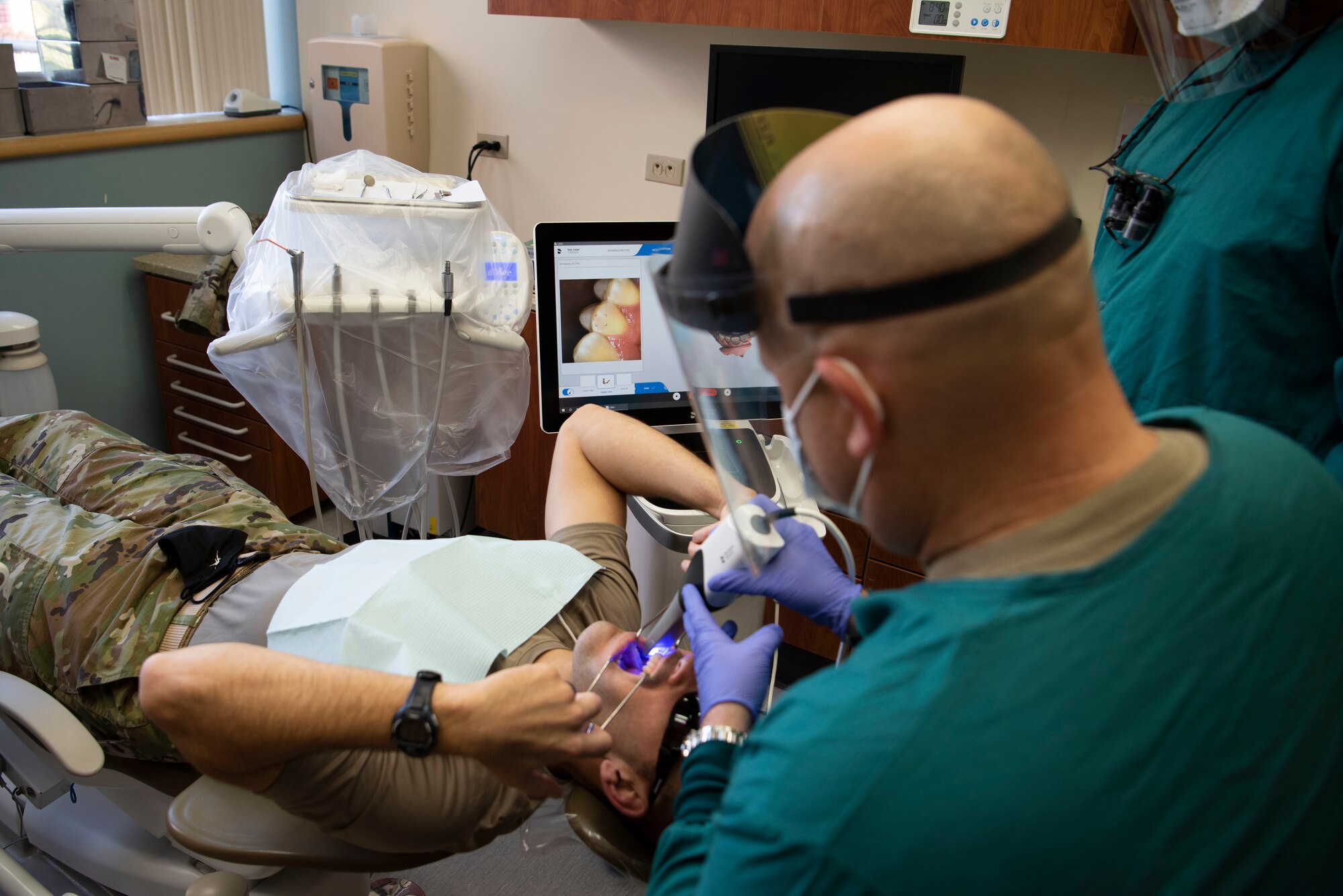 U.S. Air Force Chief Master Sgt. Robert Schultz, 60th Air Mobility Wing command chief, performs an intra-oral scan for Col. Zachery Jiron, 60th AMW vice commander, inside the dental clinic of David Grant USAF Medical Center during Leadership Rounds Jan. 22, 2021, at Travis Air Force Base, California. The Leadership Rounds program provides 60th AMW leadership an opportunity to interact with Airmen and receive a detailed view of each mission performed at Travis AFB. (U.S. Air Force photo by Airman 1st Class Alexander Merchak)