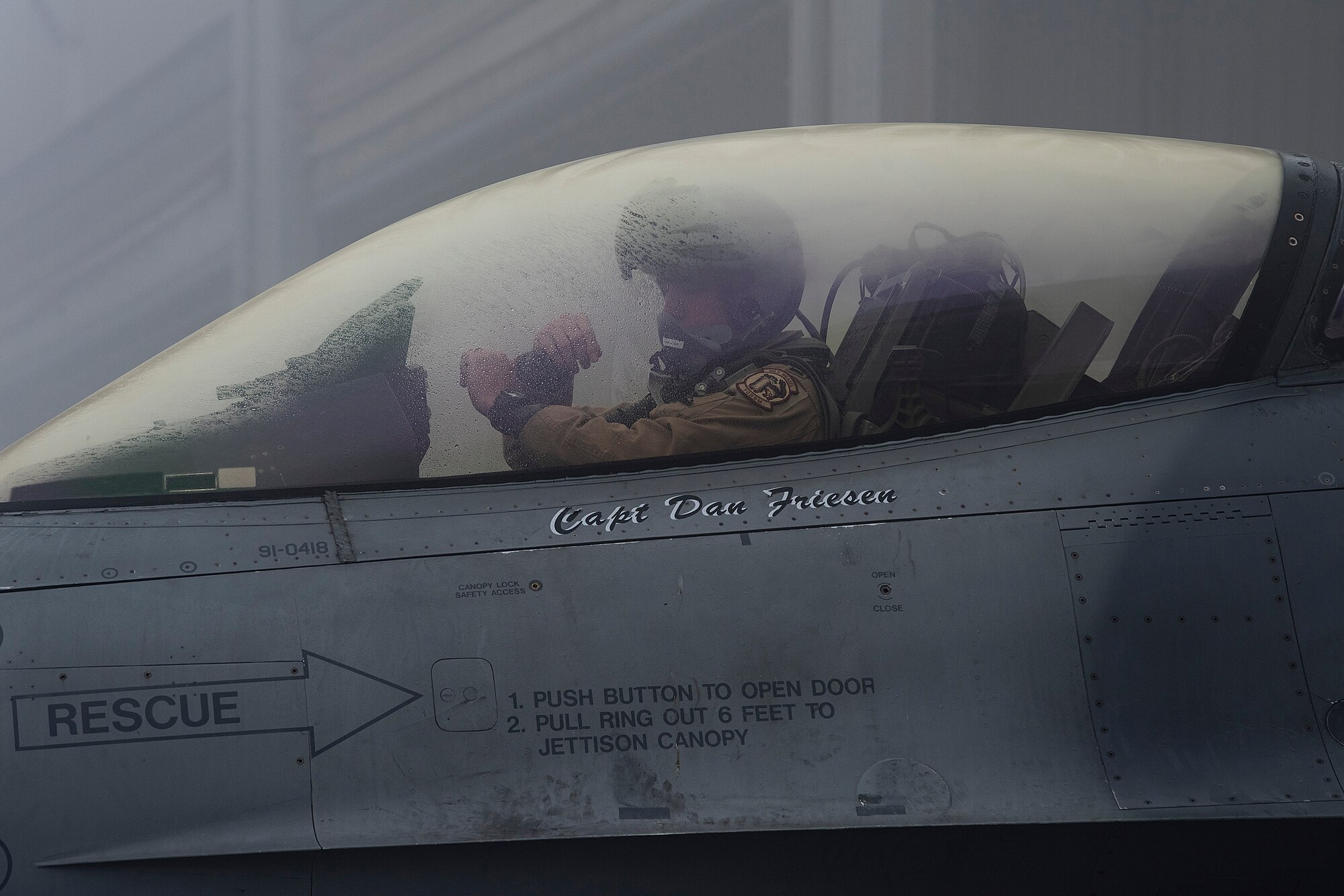 A pilot assigned to the 480th Expeditionary Fighter Squadron (EFS) signals a crew chief at Al Dhafra Air Base, United Arab Emirates, Jan. 19, 2021.