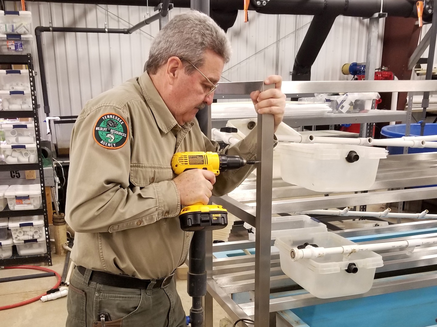 David Sims, Tennessee Wildlife Resources Agency wildlife biologist, installs an algae-feeding device Jan. 19, 2021 at the Cumberland River Aquatic Center in Gallatin, Tennessee. When the U.S. Army Corps of Engineers Nashville District lowered Lake Cumberland in Kentucky in 2008 to relieve pressure on Wolf Creek Dam, an agreement with the U.S. Fish and Wildlife Service to mitigate environmental impacts resulted in mitigation dollars being committed to the aquatic center. (Photo by Matthew Bridgers)