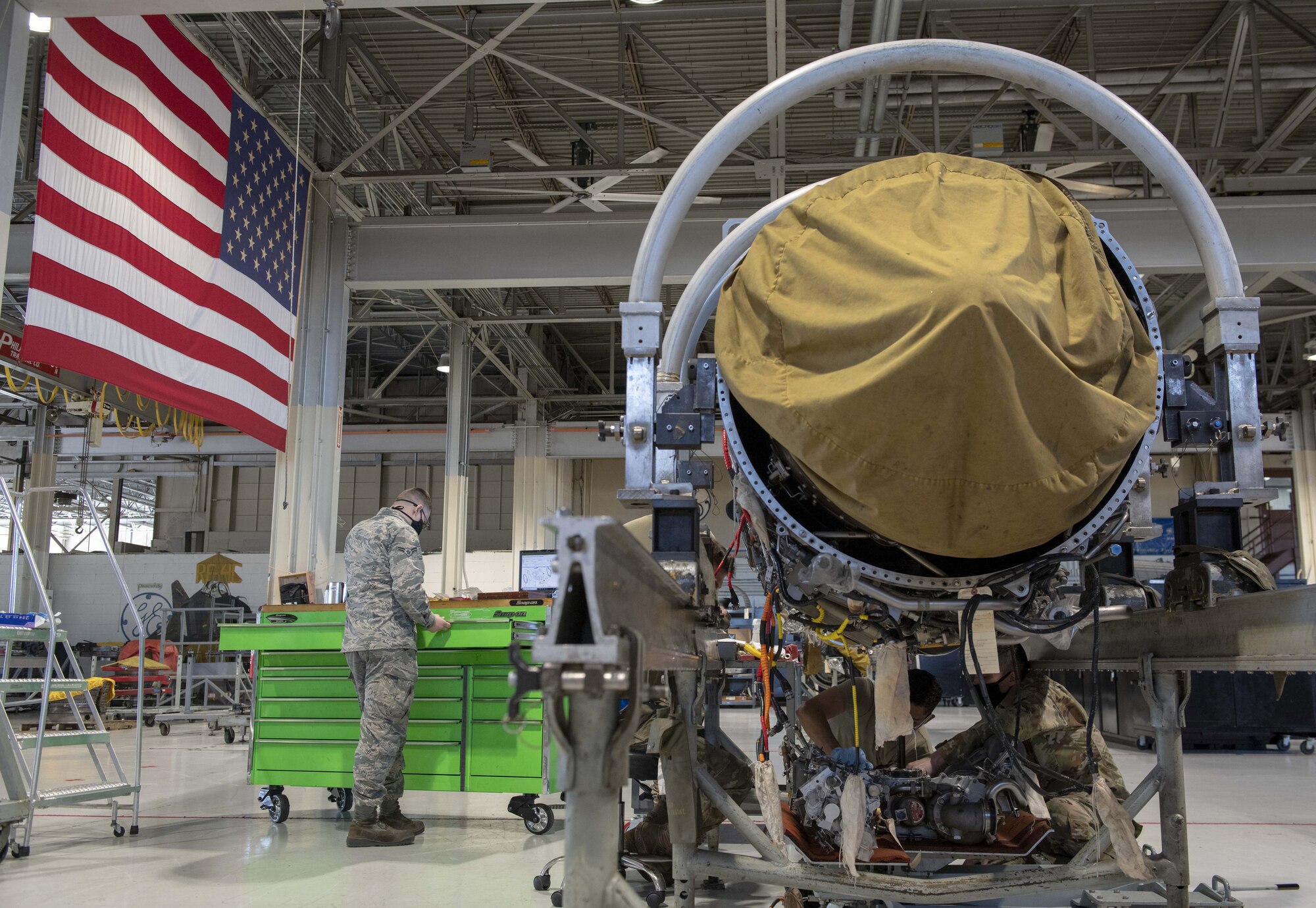 A photo of Airmen working on an F-16 Fighting Falcon engine.