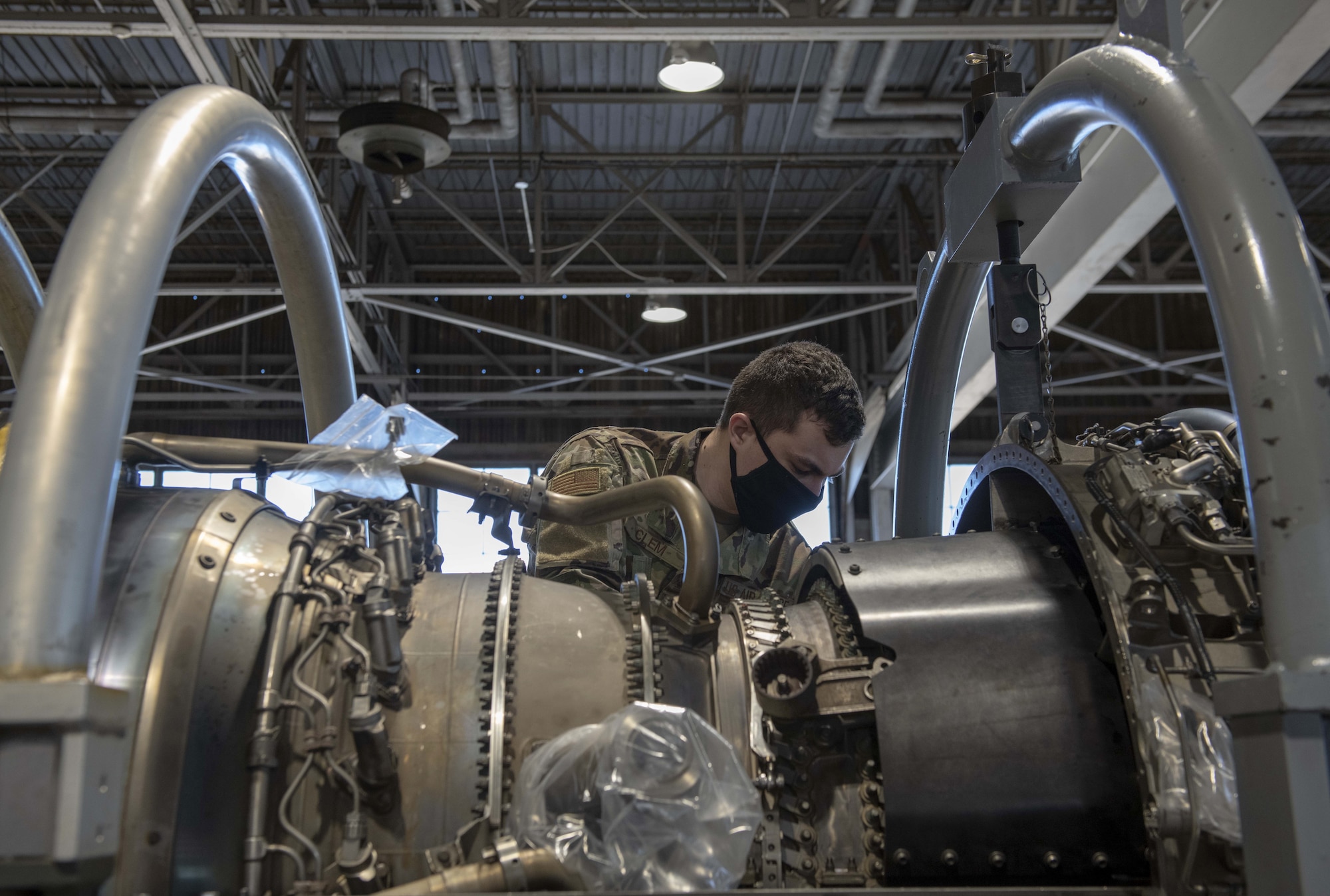 A photo of an Airman working on an F-16 Fighting Falcon engine.
