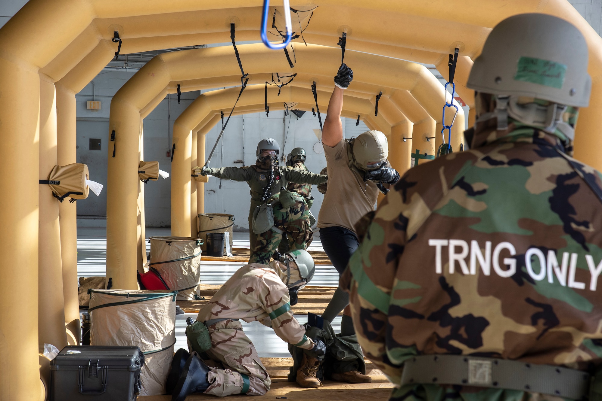 Airmen with the 6th Air Refueling Wing go through a decontamination zone during a large-scale readiness exercise, at MacDill Air Force Base, Fla., Jan. 20, 2021.