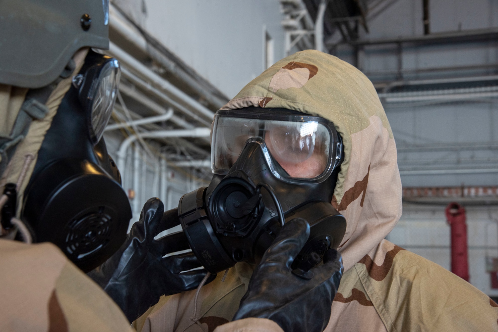 Airmen with the 6th Air Refueling Wing perform a buddy check during a large-scale readiness exercise (LRE), at MacDill Air Force Base, Fla., Jan. 20, 2021.