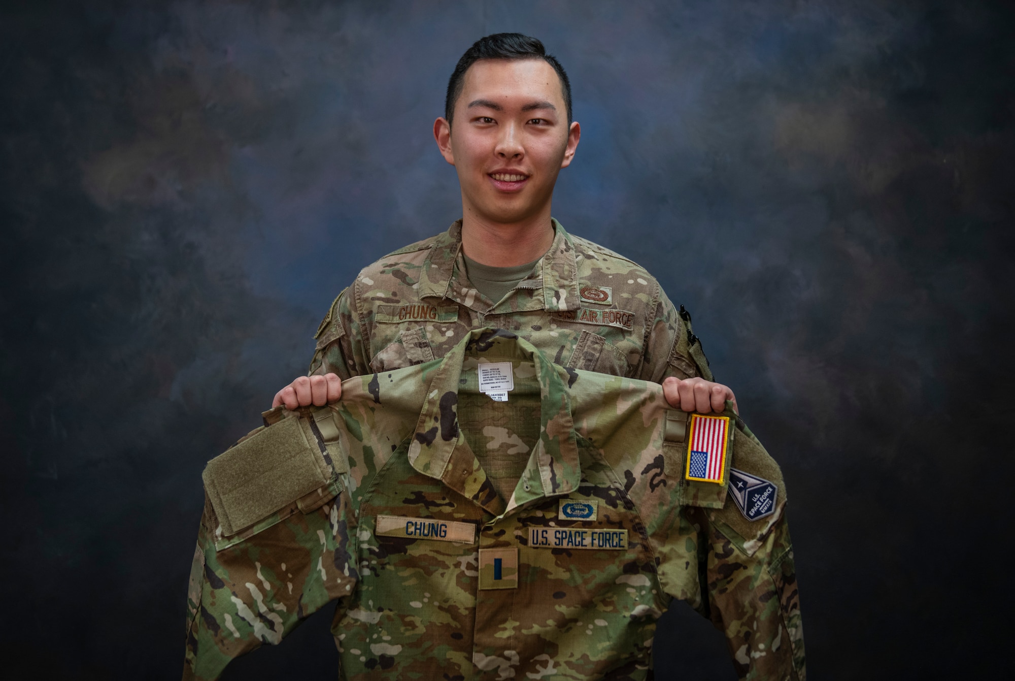 1st Lt. Issac Chung, 97th Operations Support Squadron officer in charge of intelligence operations, shows his uniform with U.S. Space Force (USSF) name tapes on Jan. 13, 2020, at Altus Air Force Base, Oklahoma. Chung applied to transfer into the USSF in May of 2020 and learned he’d been accepted in October of 2020. He is slated to swear in to the USSF on Feb. 4, 2021. (U.S. Air Force photo by Airman 1st Class Amanda Lovelace)