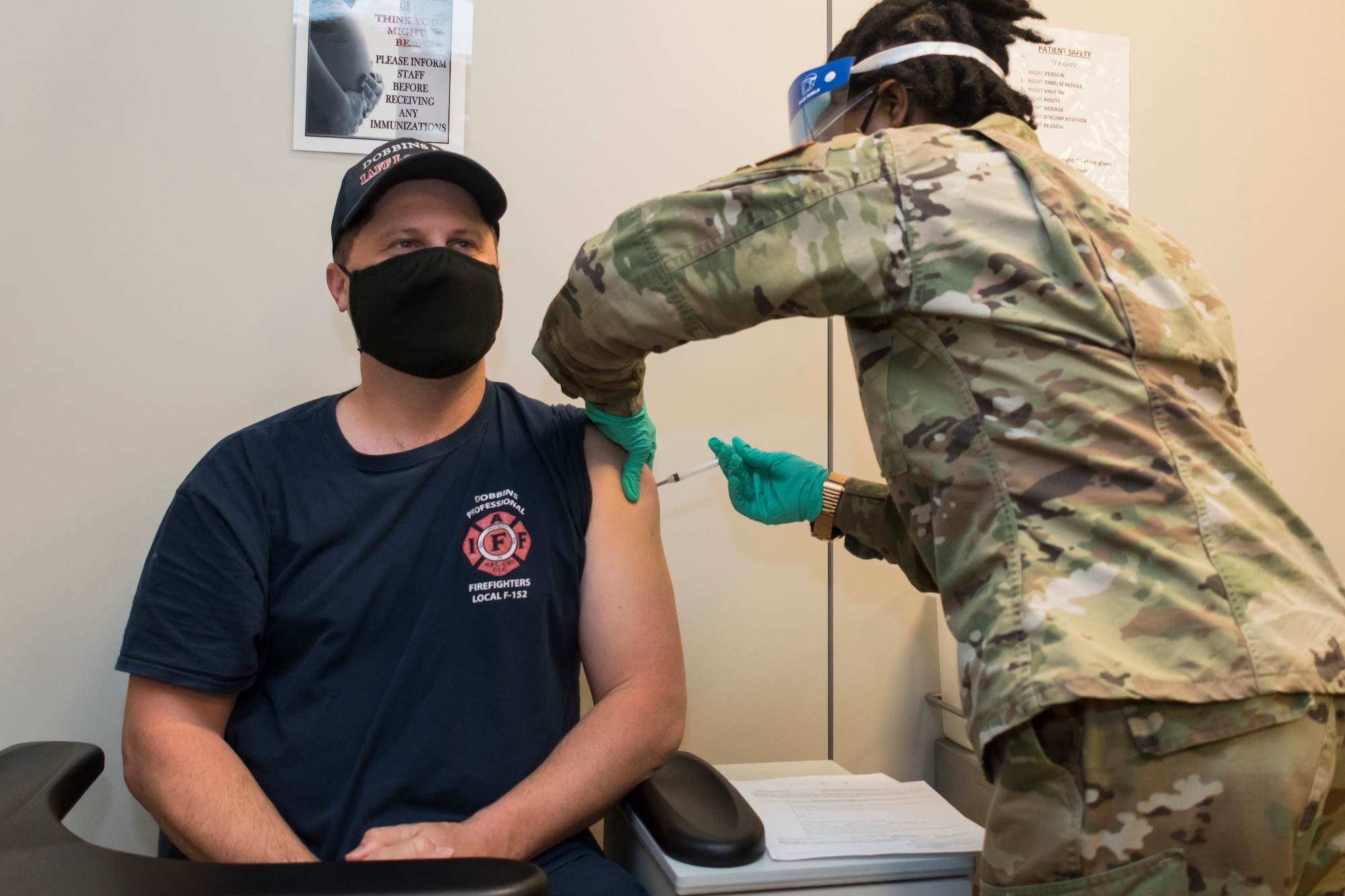 Rob Taylor, a Dobbins firefighter, is the first person to receive the COVID-19 vaccination at Dobbins Air Reserve Base, Ga. on Jan. 22, 2020. Also in the first wave of vaccinations were other firefighters as well as security forces Airmen from Dobbins. (U.S. Air Force photo/Andrew Park)