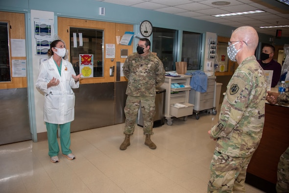 Army Lt. Gen. Ronald Place, Director, Defense Health Agency, talks with Army Lt. Col. Elizabeth Markelz, Infectious Disease Staff Physician, and Army Lt. Col. Robert Walter, Chief of Pulmonary and Critical Care Medicine, at Brooke Army Medical Center, Fort Sam Houston, Texas, Jan. 20, 2021.