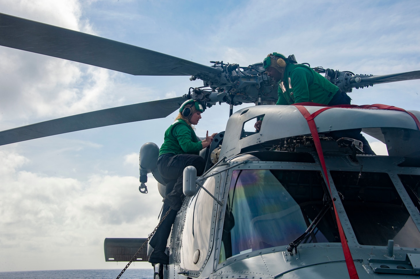 Sailors conduct pre-flight maintenance on an MH-60R Sea Hawk aboard the Arleigh Burke-class guided-missile destroyer USS James E. Williams (DDG 95).