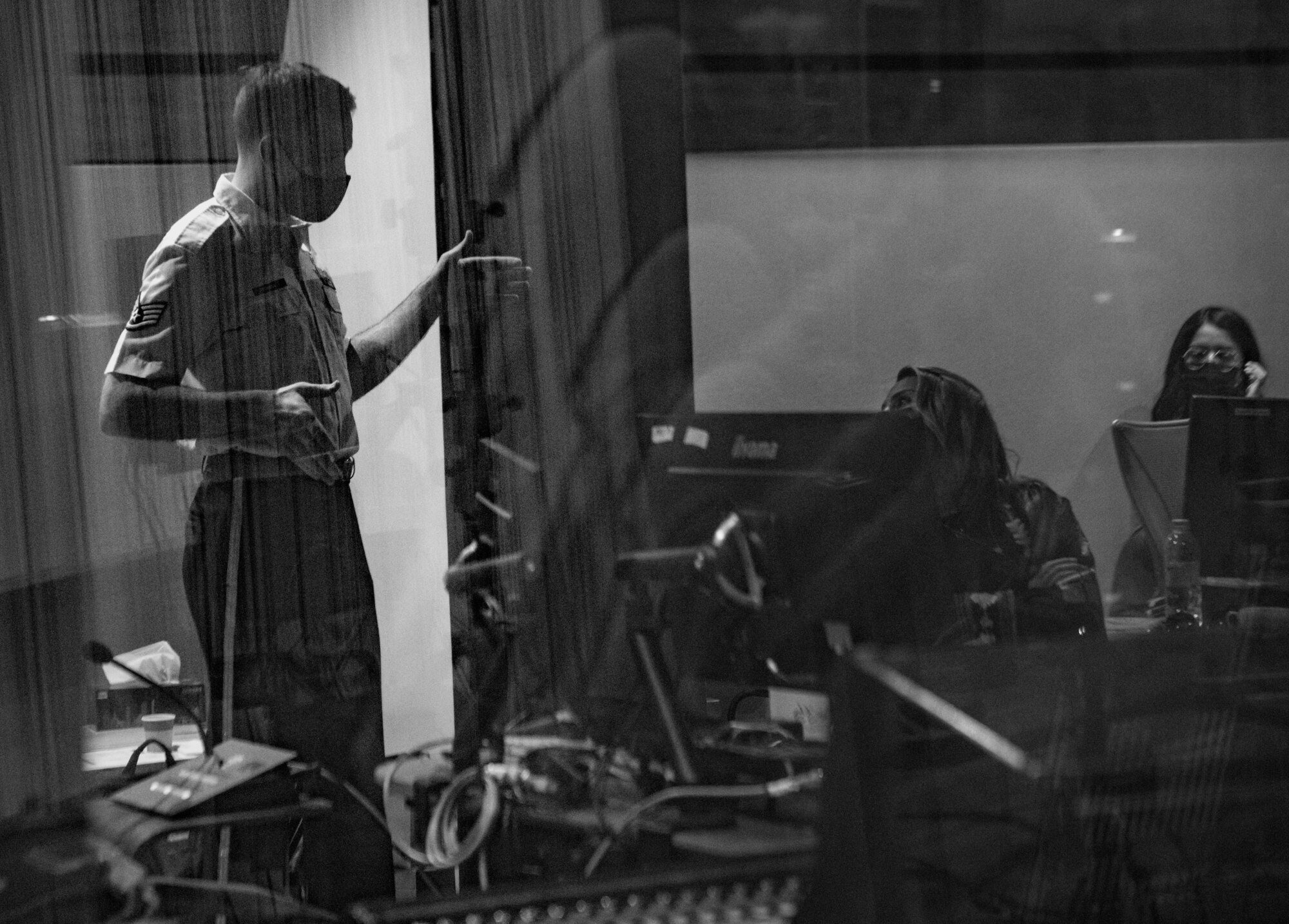 man speaks to woman in recording studio