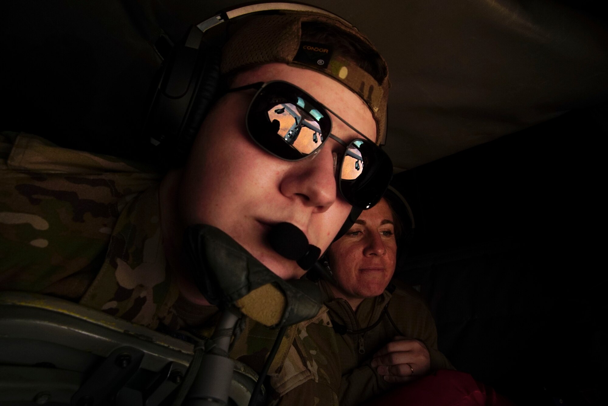 in-flight refueling specialist maneuvers the boom in order to provide fuel  to a B-52 Stratofortress during a bomber task force mission