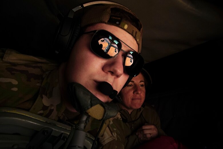 in-flight refueling specialist maneuvers the boom in order to provide fuel  to a B-52 Stratofortress during a bomber task force mission