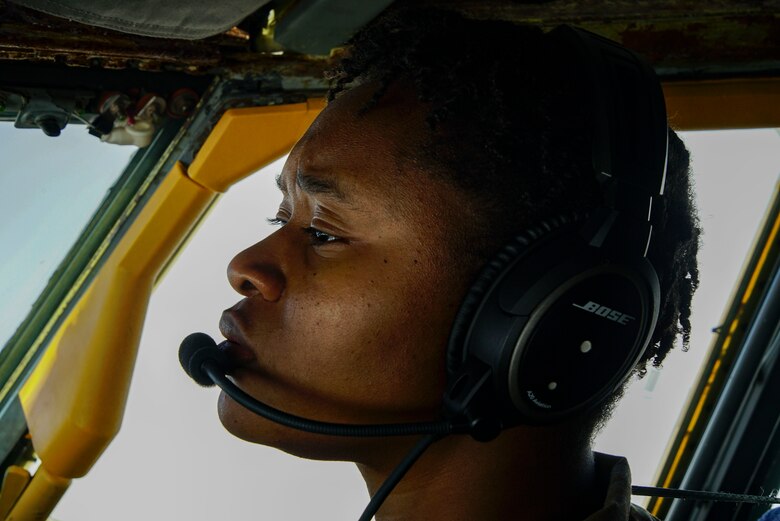 KC-135 Stratotanker crew member performs routine in-flight duties during a bomber task force mission