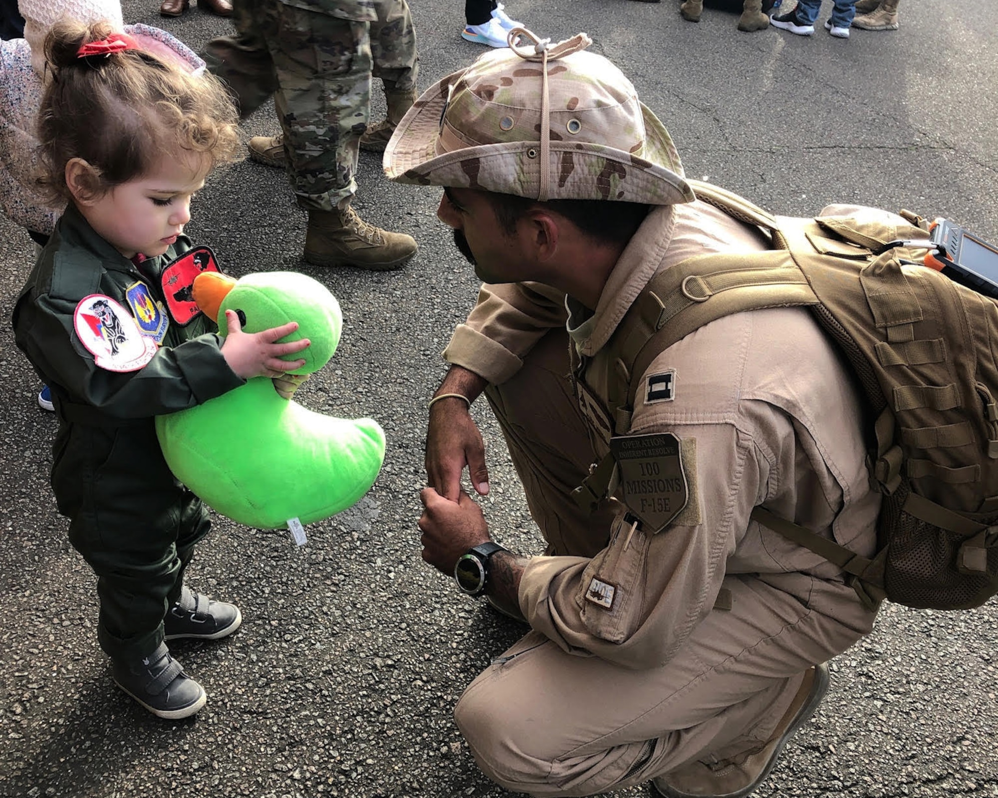 U.S. Air Force Capt. Andrew Munoz, former 494th Fighter Squadron F-15E Strike Eagle pilot and now 335th Fighter Squadron chief of plans, greets his daughter with Scoff the Duck after returning from a deployment at Royal Air Force Lakenheath, England, March 4, 2020. Munoz brought Scoff on the deployment so that his daughter could follow along with their adventures and have a connection to her father in his absence. (Courtesy Photo)