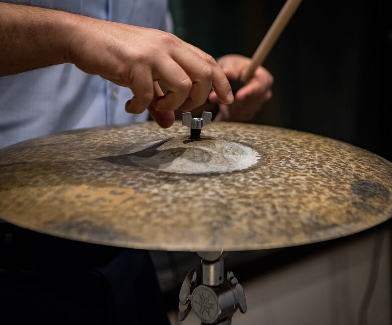 man sets up a cymbal