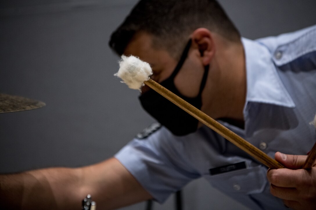 man sets up cymbals