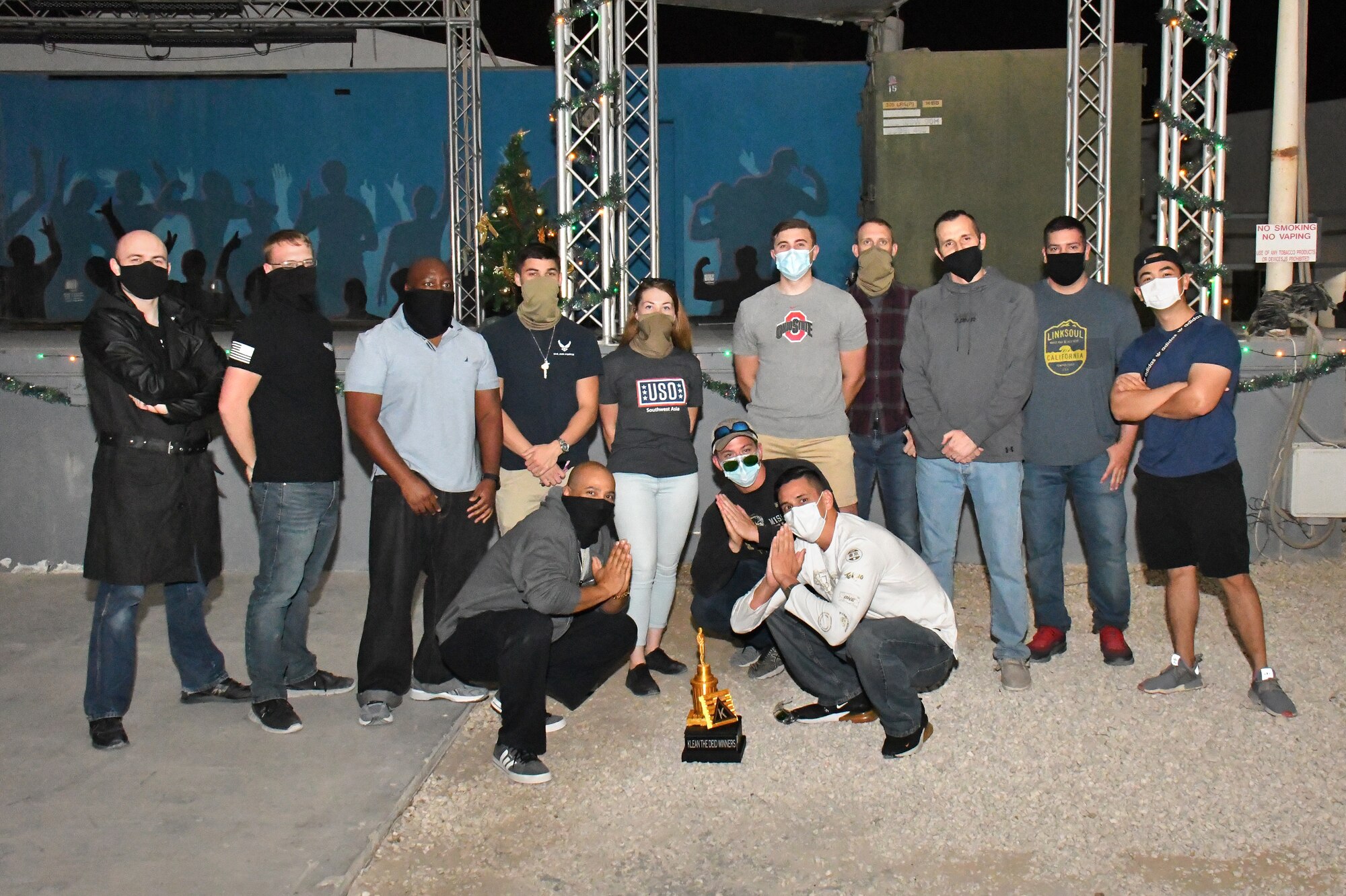 Group photo of award winners with trophy