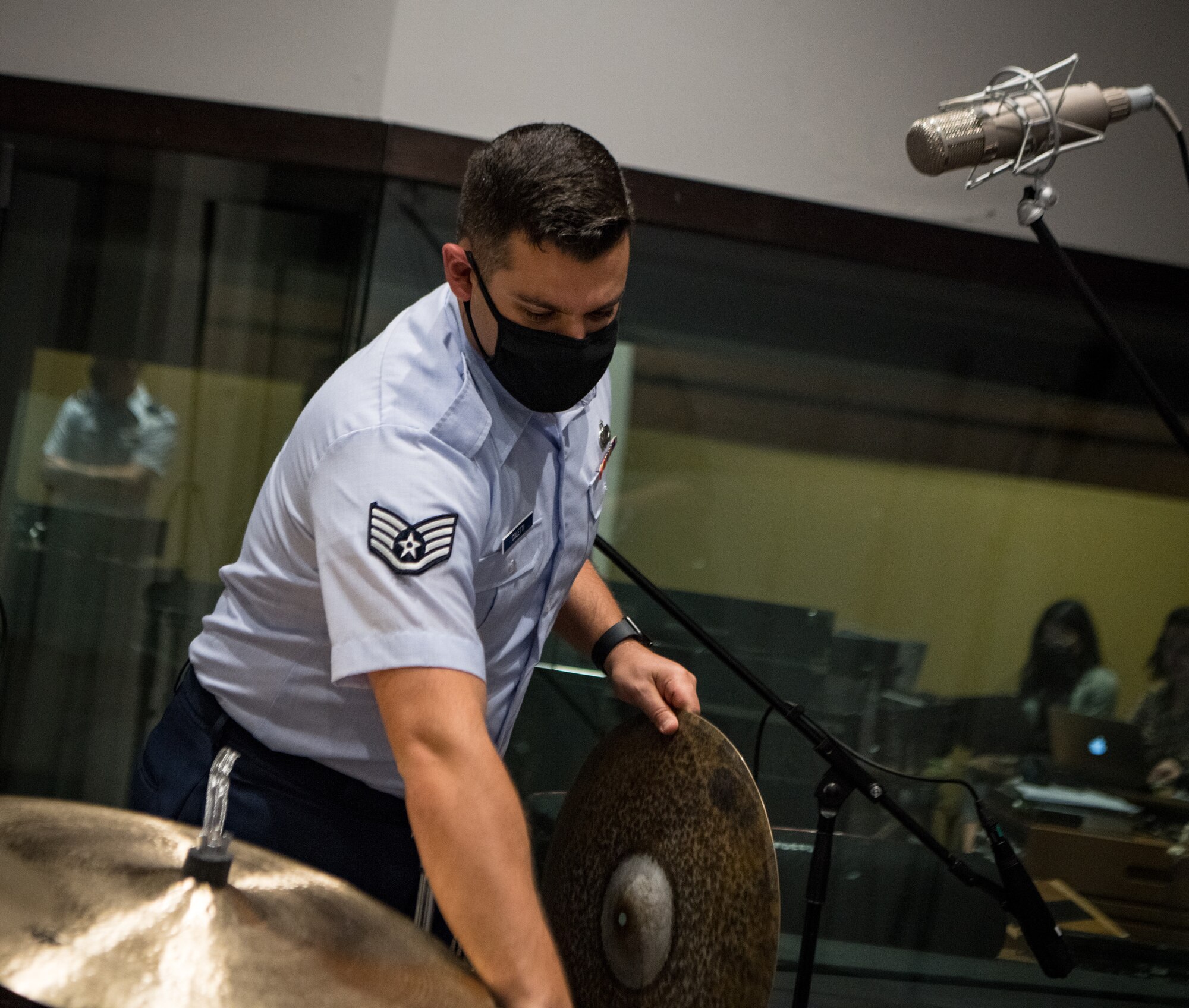 man sets up cymbals