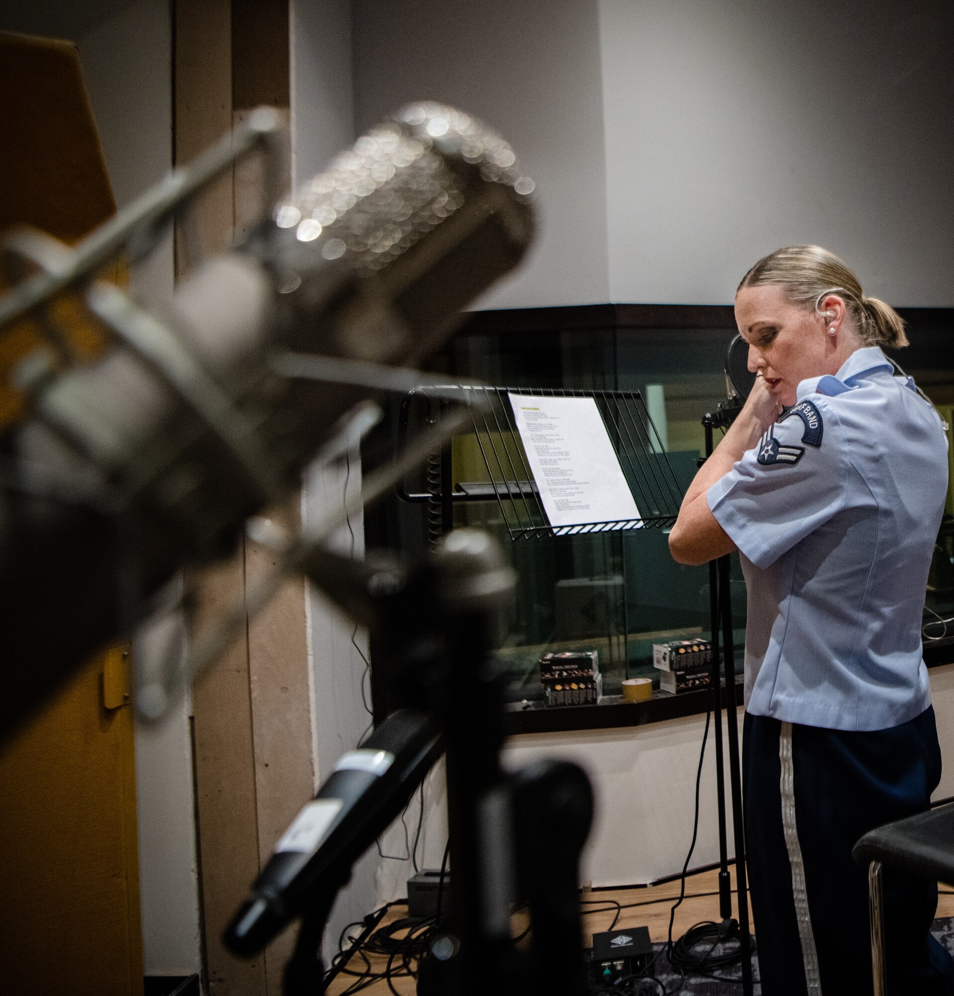 woman prepares to sing in a recording studio
