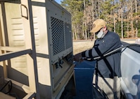 210123-N-PC620-0062 WILLIAMSBURG, Va. (Jan. 23, 2021) Dustin Bryson, a Joint Task Force Civil Support communications technician and Incident Support Team member, refuels a power generator for a mobile command tent during Exercise Sudden Response 21.