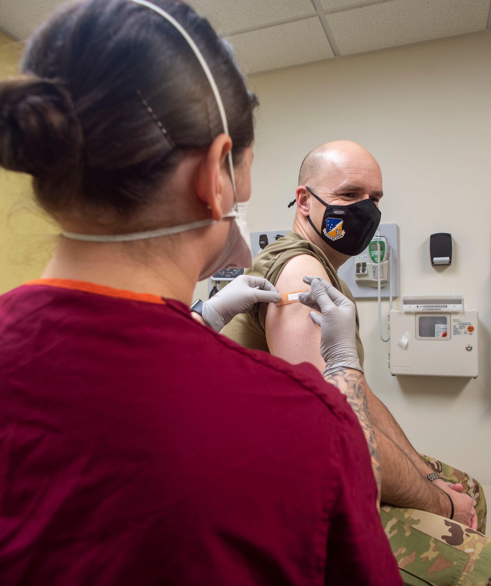 Col. Ryan Keeney, 49th Wing commander, receives his COVID-19 vaccination from Airman Melonie McMullin, 49th Aerospace Medicine Squadron technician, Jan. 15, 2021, on Holloman Air Force Base, New Mexico. All Airmen and base personnel who were vaccinated fell into category 1B: individuals 75 and older, individuals (16 and older) with underlying conditions, frontline essential workers to include Holloman AFB mission essential personnel, educators, caregivers, grocery/food staff, and vulnerable populations. (U.S. Air Force photo by Staff Sgt. Christine Groening)