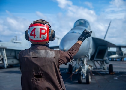 PACIFIC OCEAN (Jan. 23, 2021) – U.S. Navy Airman John Ramoslayton, from Carolina, Puerto Rico, assigned to the “Golden Warriors” of Strike Fighter Squadron (VFA) 87, directs Rear Adm. Doug Verissimo, commander, Carrier Strike Group Nine, to conduct pre-flight checks on an F/A-18E Super Hornet, assigned to VFA 87, aboard the aircraft carrier USS Theodore Roosevelt (CVN 71) Jan. 23, 2021. The Theodore Roosevelt Carrier Strike Group is on a scheduled deployment to the U.S. 7th Fleet area of operations. As the U.S. Navy's largest forward deployed fleet, with its approximate 50-70 ships and submarines, 140 aircraft, and 20,000 Sailors in the area of operations at any given time, 7th Fleet conducts forward-deployed naval operations in support of U.S. national interests throughout a free and open Indo-Pacific area of operations to foster maritime security, promote stability, and prevent conflict alongside 35 other maritime nations and partners.