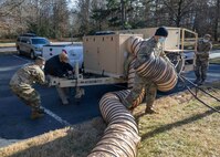 210124-N-PC620-0003 WILLIAMSBURG, Va. (Jan. 24, 2021) Joint Task Force Civil Support Incident Support Team and Forward Command Element members reposition a mobile generator near a local hotel during Exercise Sudden Response 21.