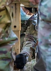 210124-N-PC620-0026 WILLIAMSBURG, Va. (Jan. 24, 2021) Army Lt. Col. Patrick Bradley, a Joint Task Force Civil Support Forward Command Element team member places a stand on a mobile generator while Incident Support Team members hold it up near a local hotel during Exercise Sudden Response 21.