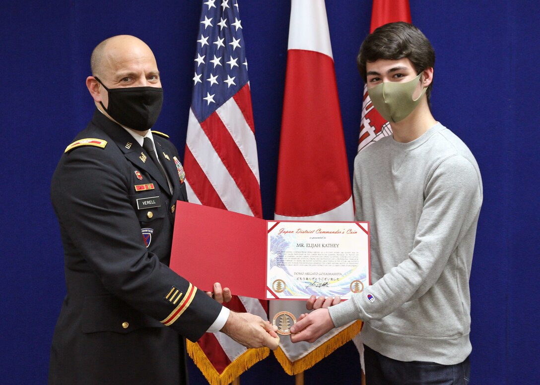 17-year-old Elijah Kathey receives his commander's coin and letter of recommendation from Col. Thomas J. Verell, Jr., U.S. Army Corps of Engineers, Japan Engineer District’s commander. Elijah was recognized upon completion of the Career Practicum Learning Program, a Department of Defense Education Activity program designed to operate as a living demonstration of the concept that education is a community-wide responsibility.