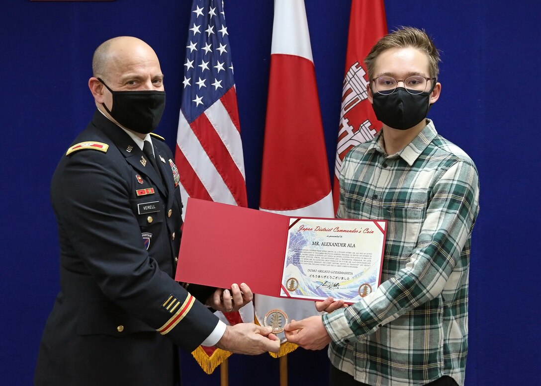 17-year-old Alexander Ala receives his commander's coin and letter of recommendation from Col. Thomas J. Verell, Jr., U.S. Army Corps of Engineers, Japan Engineer District’s commander. Alexander was recognized upon completion of the Career Practicum Learning Program, a Department of Defense Education Activity program designed to operate as a living demonstration of the concept that education is a community-wide responsibility.